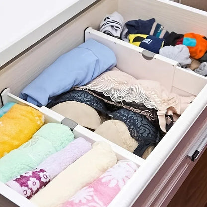 Adjustable expandable drawer dividers separating items in a kitchen drawer